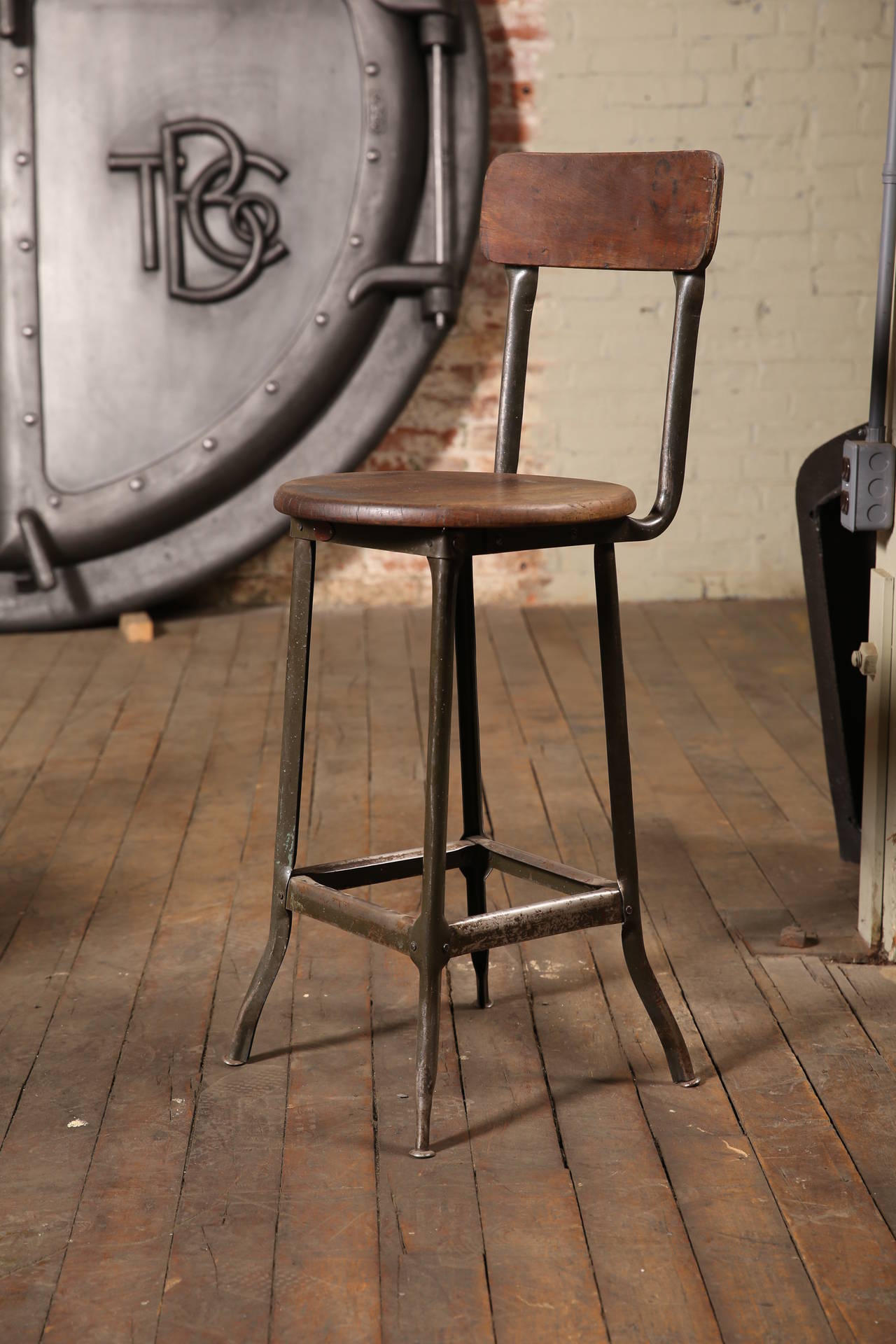 Pair of vintage Industrial wood and metal factory stools. Seat height measures 24