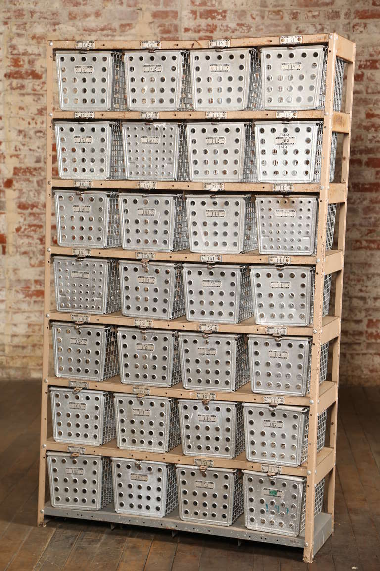 vVintage industrial furniture metal bin storage unit. 28 perforated and wire numbered bins in a metal rack.