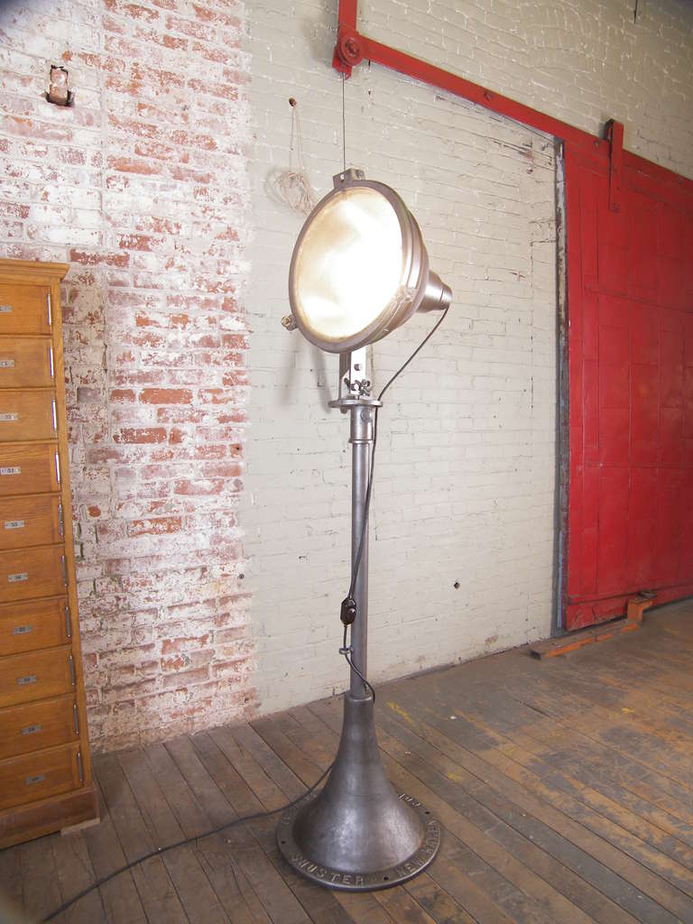 Industrial Cast Iron and Steel Floor Standing Lamp with inline dimmer switch.  Lamp head can be tilted and swivel. Base reads 