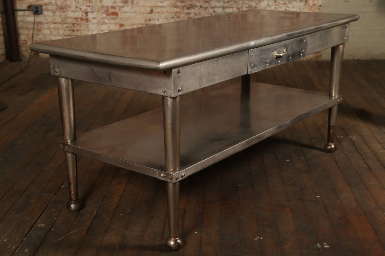 Vintage stainless steel kitchen table with tapered legs and one drawer. Shelf height measures 15