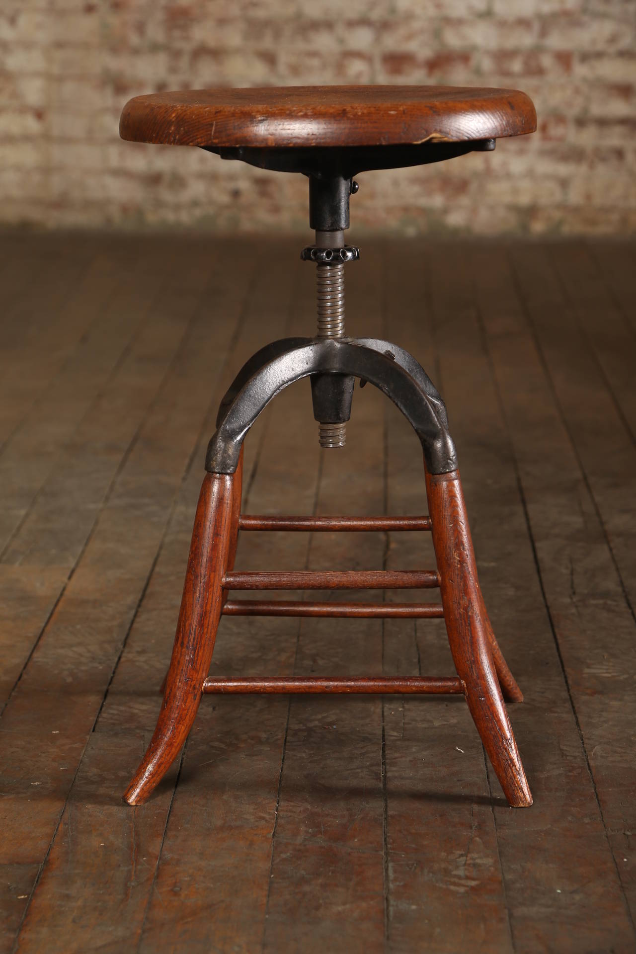 Vintage Industrial adjustable furniture. Vintage Industrial adjustable oak wood stool with cast iron frame. Stool height adjusts 20 1/4