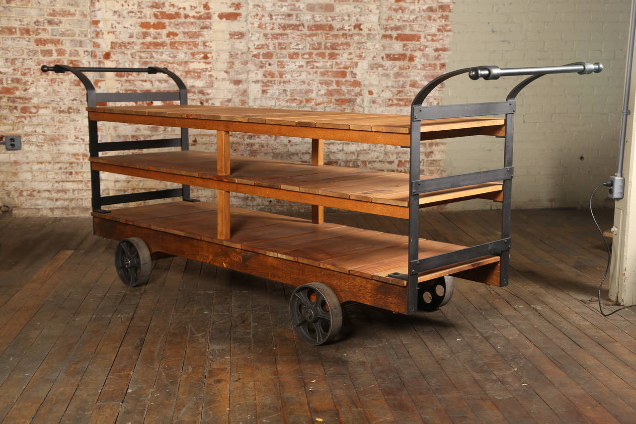 Vintage industrial rolling display or storage cart with hanging racks. Top shelf height is 36", middle shelf height is 25" and bottom shelf height is 13".