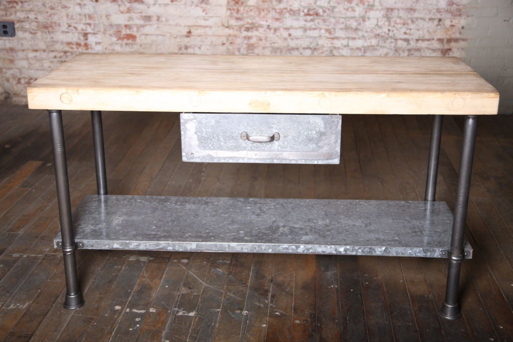 Vintage industrial (Maple) butcher-block top with steel round legs and metal shelf and draw.  (Similar others available.)<br />
72