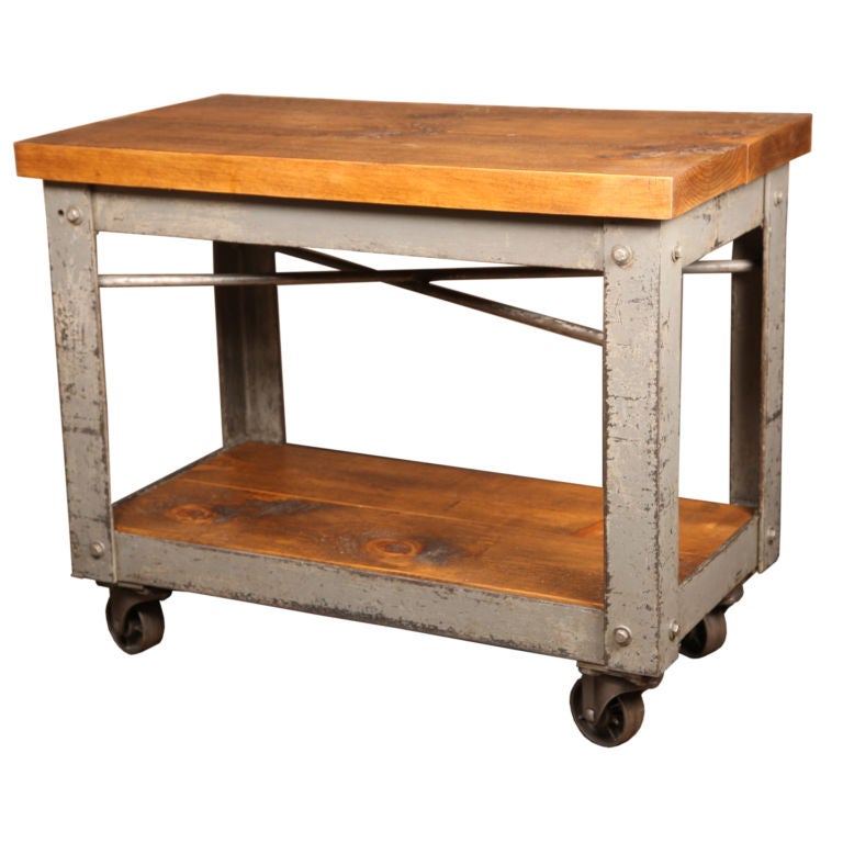 Vintage Bar Cart with cast iron wheels and wooden shelves.