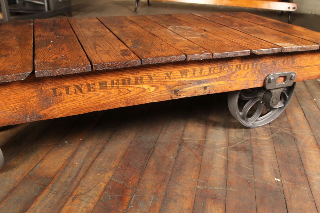 Vintage Industrial Linberry Cart - Rolling Factory Machine Coffeetable, Made From Wood & Cast Iron. Two Larger Wheels at the Back and Two Smaller Swivel Wheels - Castors. Table top Measures 48