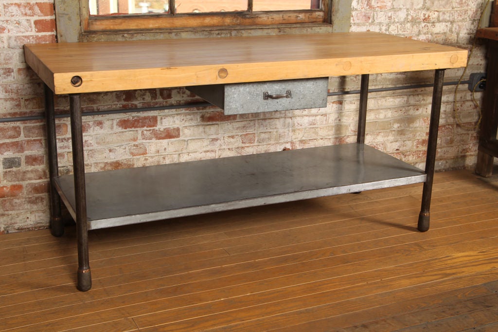 Vintage industrial butcher-block top with steel round legs and metal shelf and draw.  Lower shelf is 11 3/4