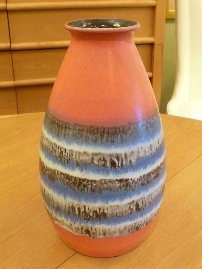 Good scale large mid-century drip glaze pottery vase from Dumler & Breiden of Hohr-Grenzhausen, Germany.  The vibrant coral color is centrally encircled with a belt of slightly textural drip glazes in blues, browns and creamy white to great effect. 