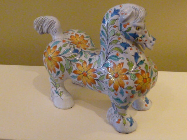 Midcentury and magnificent! This Italian ceramic horse is instantly a favorite with its big broad draft horse shape entirely decorated in relief and in vivid colors, fantastic flower forms. A very friendly mystical beast, beautifully realized. A