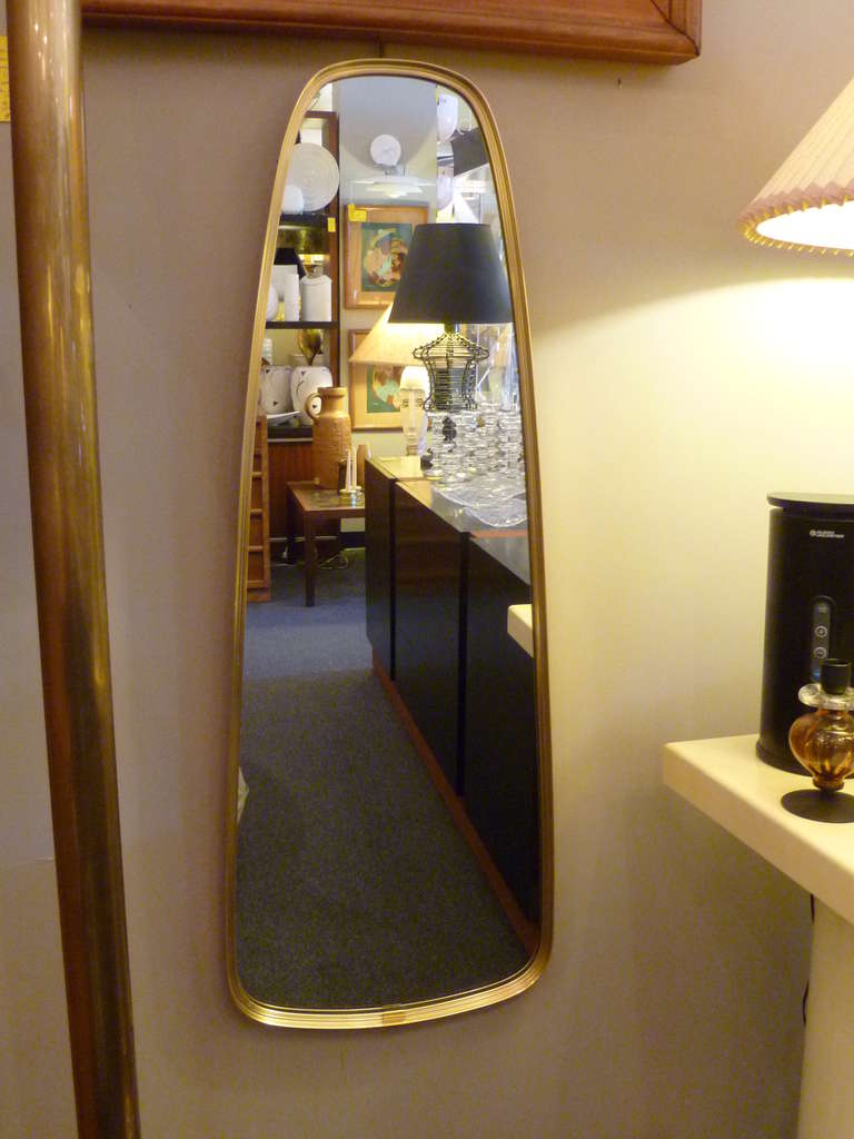 ...SOLD...With a glamorous and decidedly 1950's shape and form, this Italian Brass mirror is elegant, modern and captivating. Wide at the bottom and narrowing as it rises. Just beautiful.

Measurements:
40