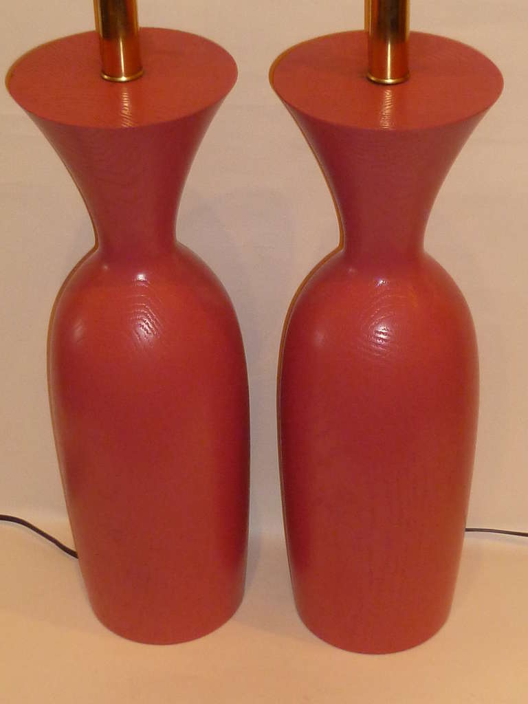 Pretty in vivid coral pink, this pair of solid oak table lamps have a lathe turned urn form with brass mounts and have been rewired and have new UL brass three way sockets. Just add your shades!   Price is for the pair.
Measurements:
Height to