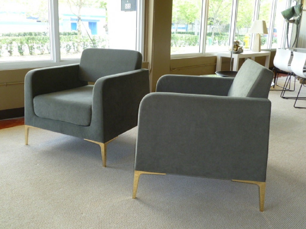 SOLD  Exceptionally swank this pair of club chairs with lounge appeal. Bright & shiny Ponti style brass legs, sculptured shape, neutral olive grey plush micro-fiber velvet  and lower open back design makes for a pair of impressive & comfortable room