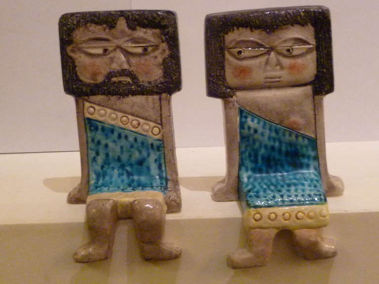 ..SOLD...Whimsical pottery  ceramic offering from Marcello Fantoni of shelf sitters depicting a pair of  flirting ancient toga clad man and woman.  Often described as cave people, their outfits suggest a more evolved society, say Babylonian or