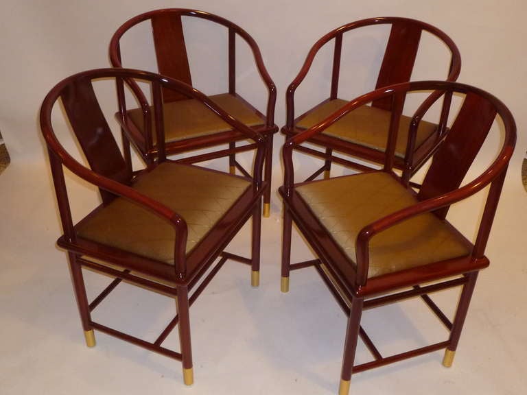 With an elegant Chinese flair, this set of FOUR chairs designed by Stanley Jay Friedman for Brueton have a hand carved mahogany frame with delicate chinoiserie compound curves, featuring bronze gold toned silk upholstered seats and a wide curving