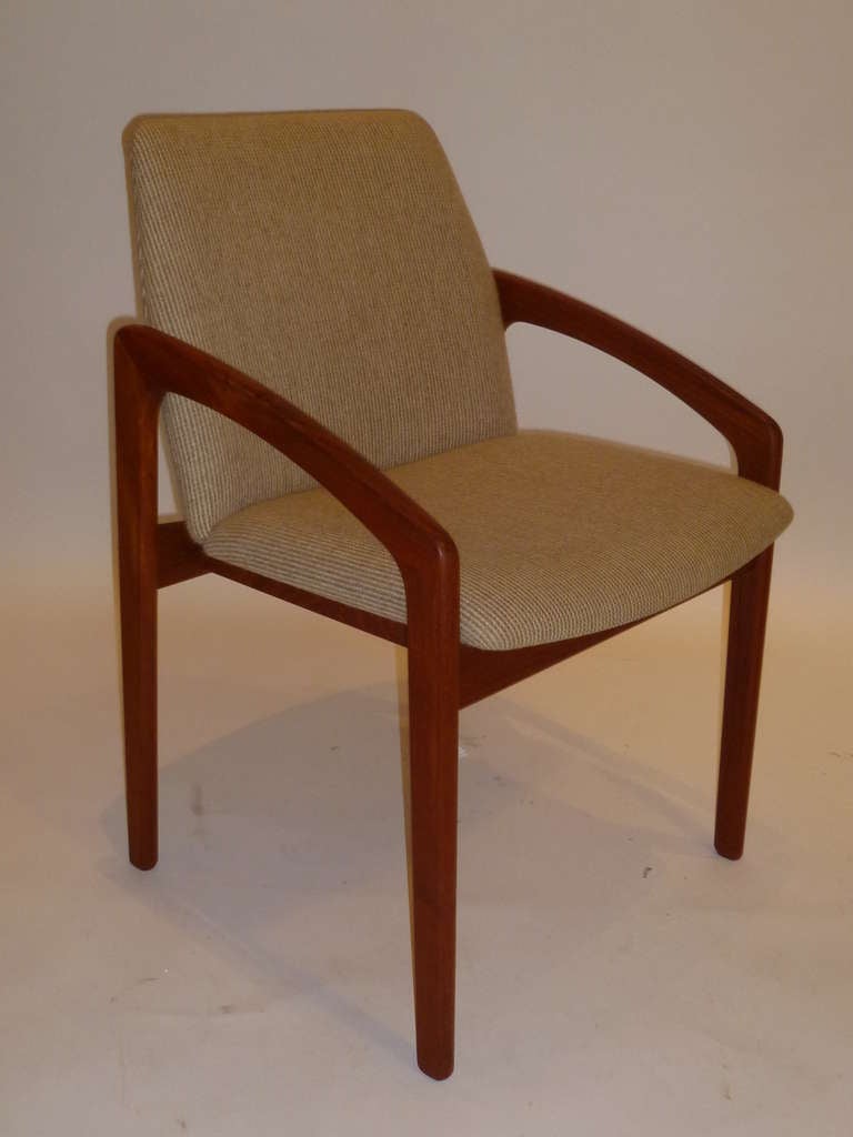 SOLD Sensuously shaped teak arms & legs and a body cupping seat highlights this Kai Kristiansen chair produced by Korup Stolefabrik (Model designed 1955). Classic Danish styling. Original neutral beige/cream weave wool fabric. K/S brand on seat