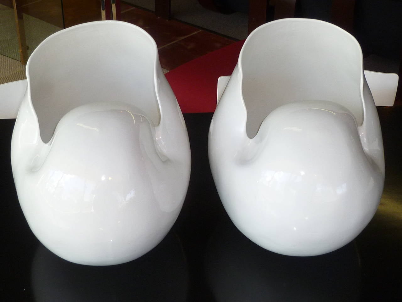 Monumental sculptures, this pair of white ceramic Nautilus shell form vessels are large vases or cache pots.  Wonderful architectural elements, their size makes a statement.  Beautifully smooth, captivating.  Ink stamped under the glaze on the