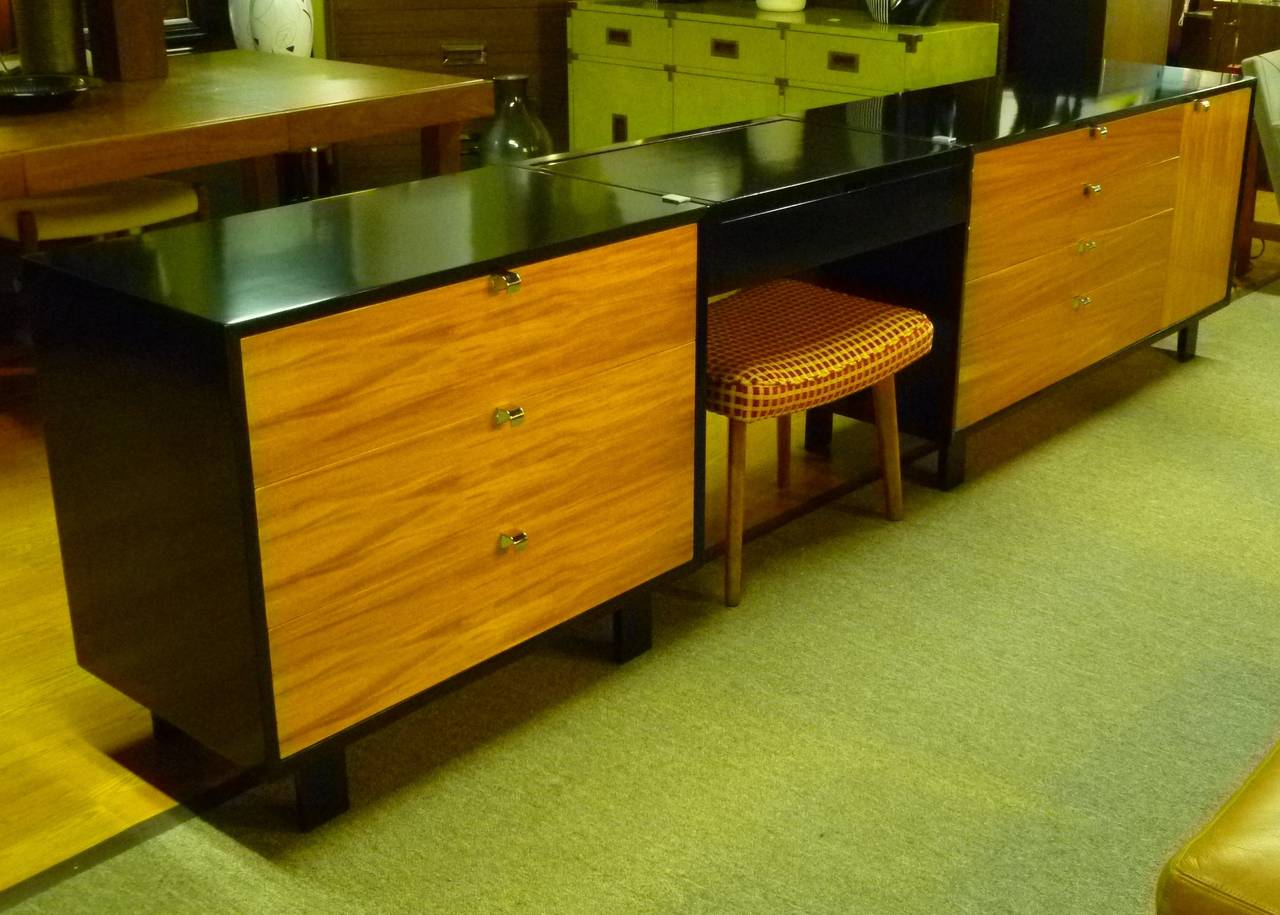 SOLD  A most sophisticated edition of George Nelson's dressers and vanity grouping for Herman Miller, here in blond & lustrous Primavera wood and black lacquer.  Featuring a three drawer commode on one end, a centered flip top vanity table with