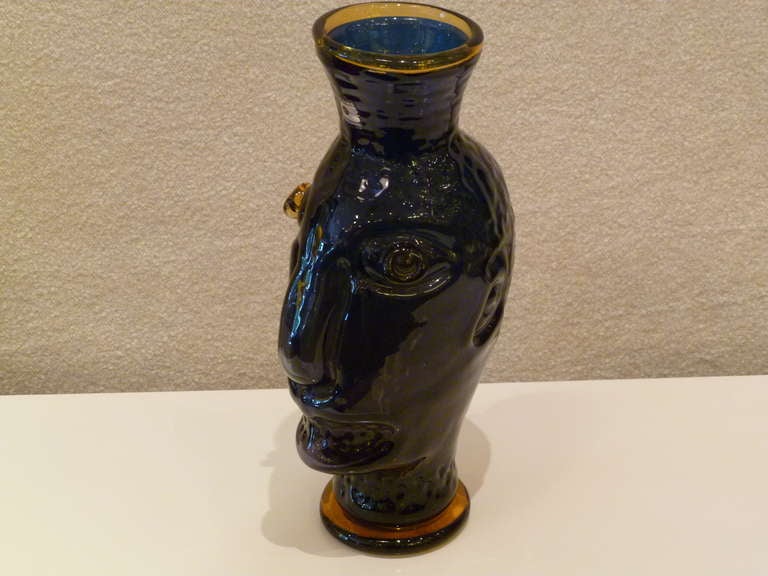 SOLD  Hank Murta Adams, glass artist extraordinaire, designed this jughead vase while he was Artistic Director at Blenko from 1988-94.  Blown thick glass in cobalt and topaz, Blenko colors.  Perhaps inspired by historical face jugs, the head has