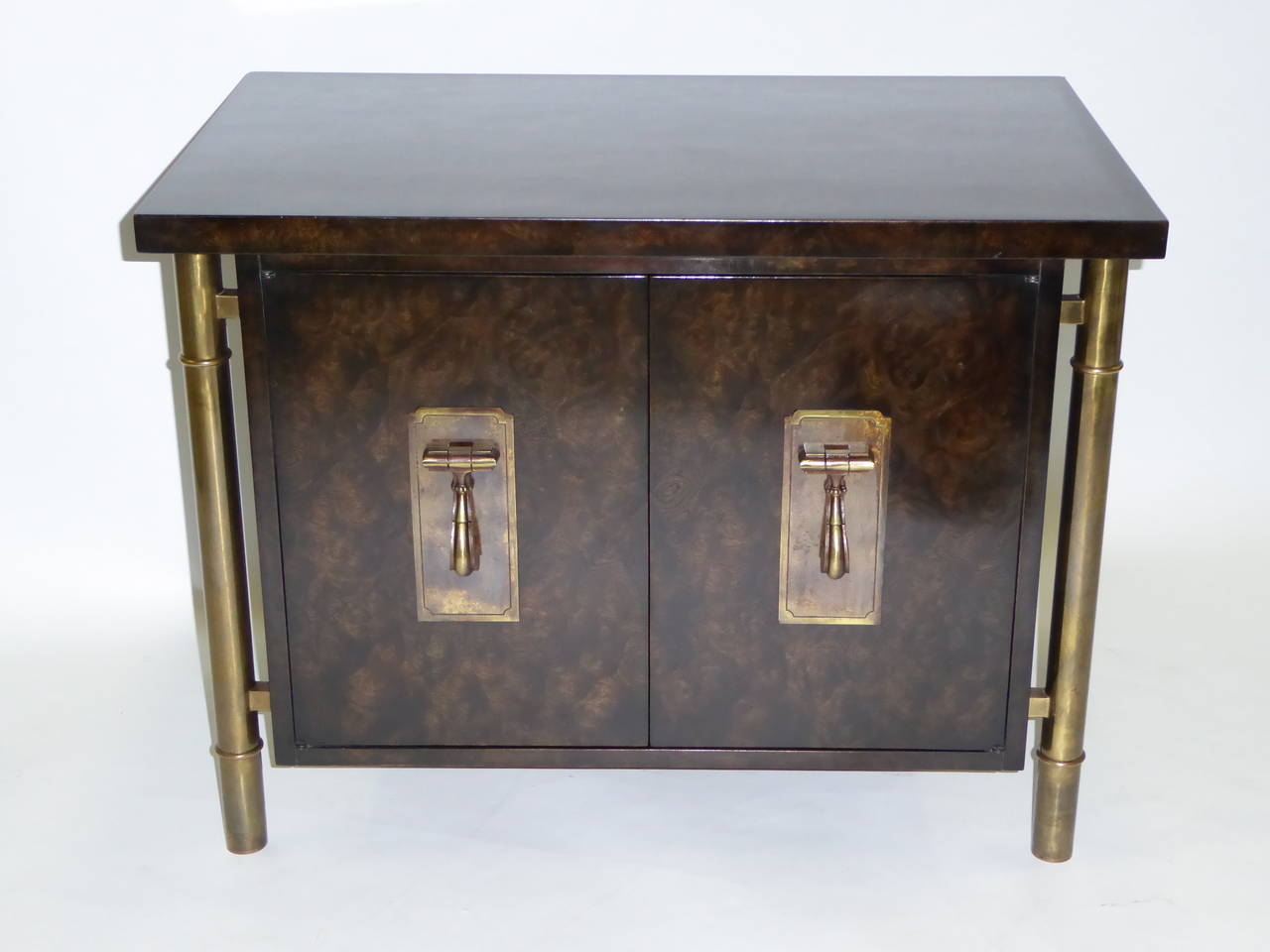 Fine and elegant bedside table by Mastercraft in elm burl with brass legs and pulls. Designed by William Doezema, co-founder of Mastercraft. Doors open to open cabinet with adjustable shelf. As a night table, end table. Exquisite!

Measurements:
32