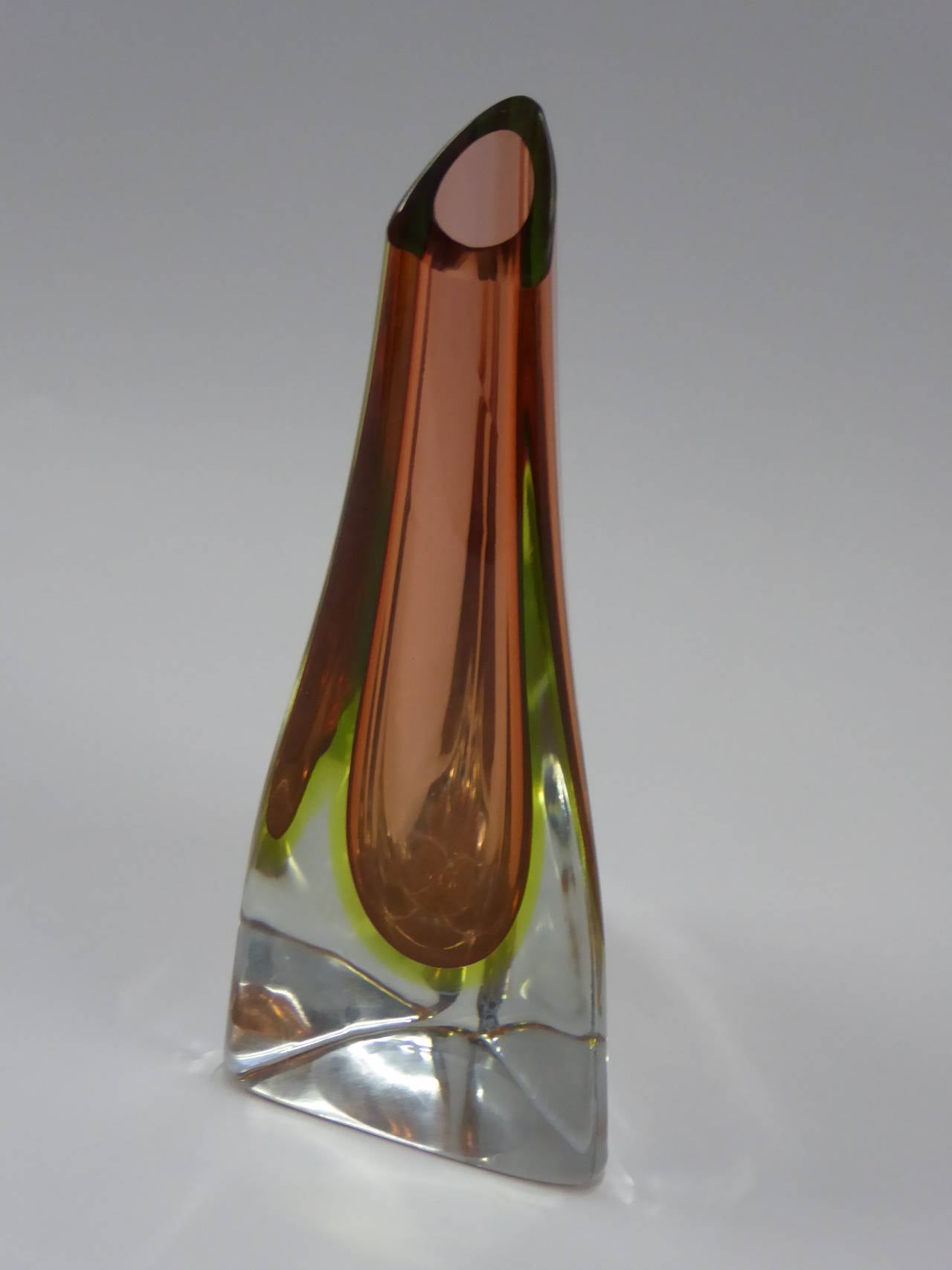 SOLD  Three-sided or trifoglio, this Cenedese Sommerso vase has pink casing and uranium green inside clear crystal blown glass and a slanted mouth. Exquisite Murano vase. Unsigned.

Measurements:
9 1/2