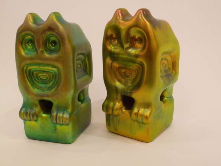 ...SOLD...Bohemian Modernism.  These irridescent green eosin glazed stylized owls standing on a base by Judit Nador for Zsolnay, the reknown Hungarian porcelain firm are mesmerizing, surreal and utterly enchanting.  Like a pair of sphinx or
