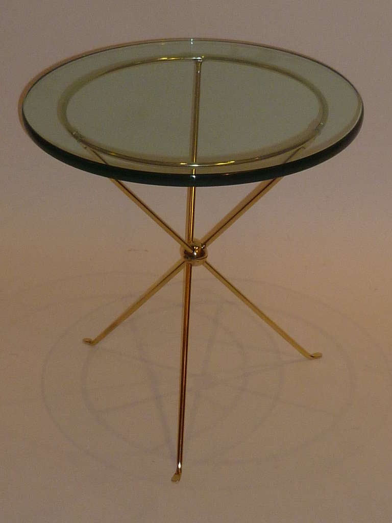 SOLD With the fineness of a Gio Ponti design, this trim modern stylized neoclassical form occasional table in tripod polished brass with 3/4