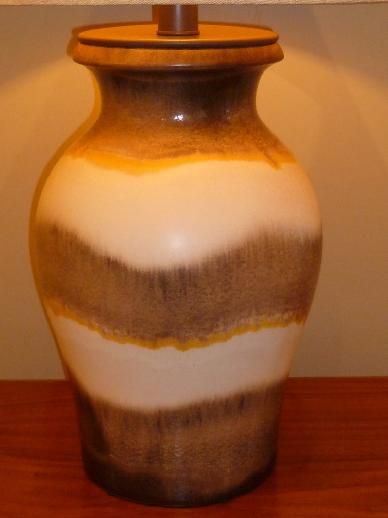 Large and impressive midcentury Raymor import, a table lamp of a German lava glaze pottery vase mounted as a lamp, probably Scheurich pottery. Fat and appealing shape, at once masculine and strong. The colors of chocolate brown with mustard yellow