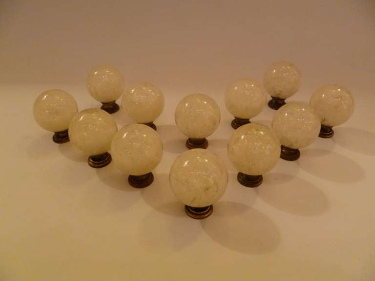 SOLD  A luxe set of twelve lucite drawer/cabinet pulls with bubbly inclusions by interior designer and home  builder Ruth Richmond of Sarasota, Florida.  With dark brass mounts, the clear lucite balls have interior explosions of bubbles making them
