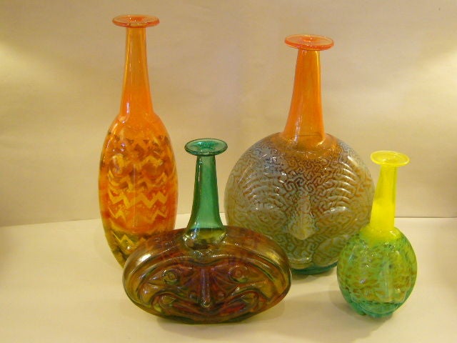 World renown and noted Swedish glass artist Kjell Engman created this group of whimsical blown glass bottles with comical faces for Kosta Boda in the 1980s. Named 