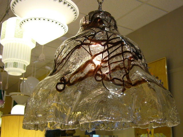 REDUCED FROM $1,500....Like a frozen waterfall, this large Mazzega chandelier of thick draped glass is awesome. Seemingly freeform, it does have a  flaring bell shape. The clear thick glass also has a chocolate syrup like drizzle in the glass. Bosco