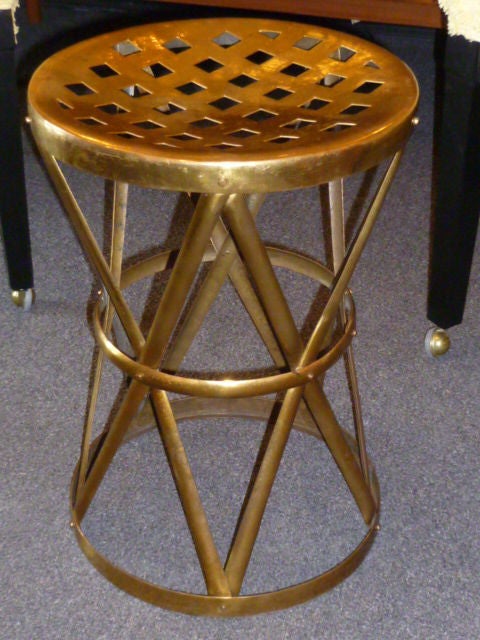 SOLD  Very chic with its belted waist and unusual pierced top, adding warm gold to the mix...this small and mobile hammered brass table with its exotic crossed strapwork rises to the occasion, always at hand when needed. Mixes with any period decor.