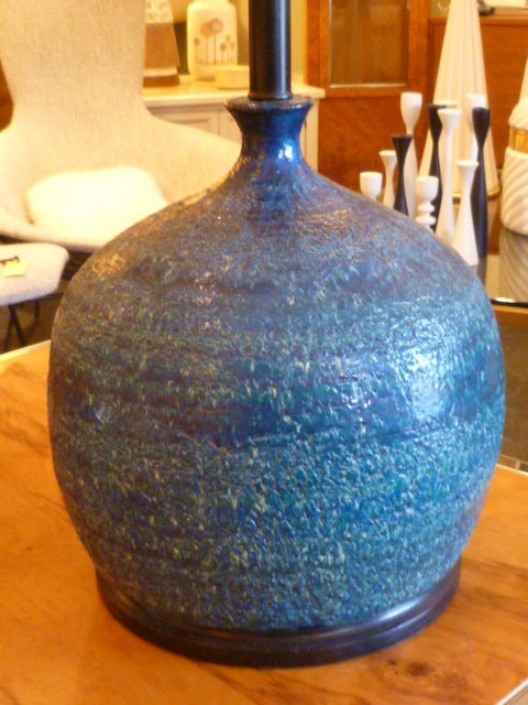 ...SOLD JUNE 2012... Aldo Londi created Rimini Blu, a wonderful glaze mix of blues for Bitossi and the rest is history.  Here, a really fun molto grasso, fat orb of a table lamp.  Resting on a ebonized wood socle base like a bursting balloon or