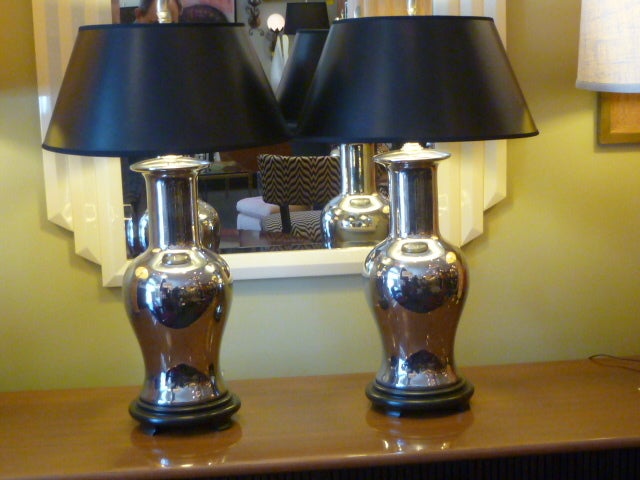 Exquisite and elegant in a Classic vase form, these mirror glazed porcelain lamps appear as mercury glass, reflective in an antique grace fullness. Ideal for all rooms, the bedroom, the living room. Just add your shades. We love them with black