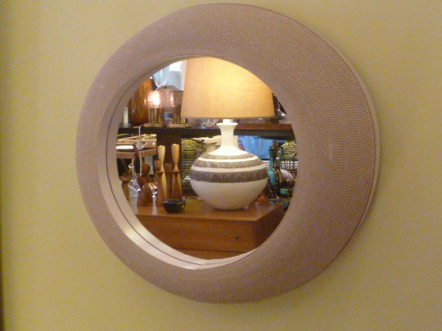 What a great mirror!  Fun, stylish and wonderfully imaginative in design, this porthole shaped mirror was created by Flute in the early 80's.  It is made of spiraling corrugated paper.  The shape is great...streamlined and modern.  The corrugation