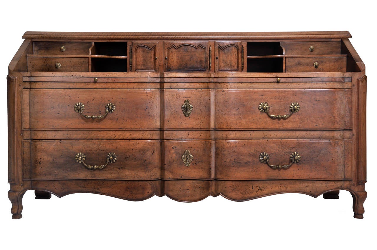 Vintage 1960s Italian walnut desk by Richard Wheelwright. The desk has two large drawers with brass handles. A pull-out board pictured in image 1 is for writing or your laptop. Four small upper drawers with open shelves and small doored recessed