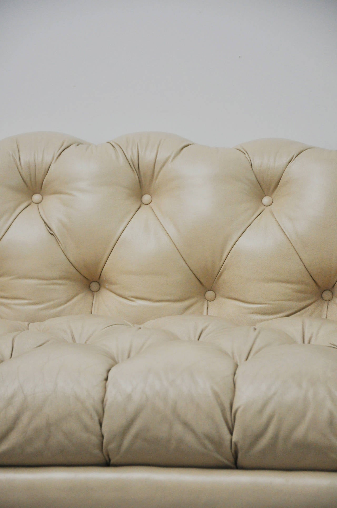 Two exquisite light tan leather Chesterfield style sofas with nailhead trim by Hancock and Moore. Comfortable and in beautiful condition. Leather is a tan off-white color.  Sold separately.