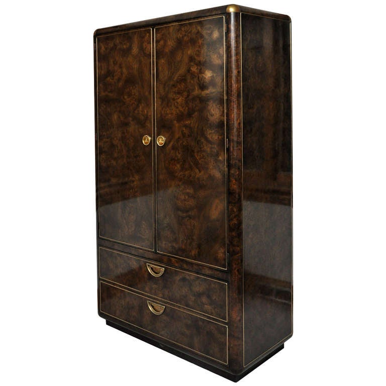 Beautiful Mastercraft Burled Amboyna-Veneered Armoire with inlaid brass trim and handles. Interior has an open shelf storage area with four full length drawers, in addition to the two full length drawers on the exterior.

In excellent condition.