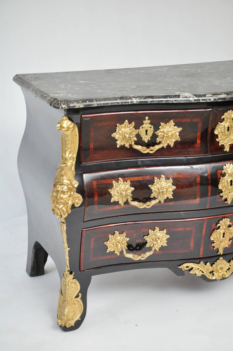 Magnificent 18th century Louis XV parquetry commode with original period bronzes, circa 1740.

Includes two full length drawers, two half drawers and one hidden drawer. 

Original grey and white marble top in exceptional condition.

The piece