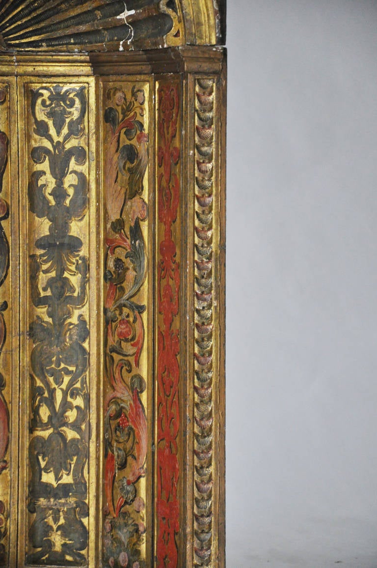 Exquisite 18th century Italian gilt and polychrome niche. Original gilt and polychrome painted finishes with ornamental designs typical of the period. Wonderful coral and deep blue hues are beautifully rendered on top of a gilt finished