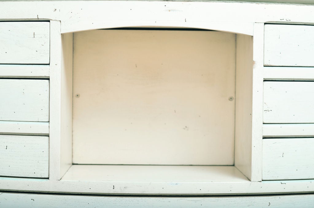 19TH CENTURY LARGE CURVED CABINET FROM A FRENCH CLOTHING STORE.  THIS MARVELOUS ONE OF A KIND LARGE SCALE DRESSER HAS 17 ANGLED DRAWERS AND 4 CABINET DOORS.  24