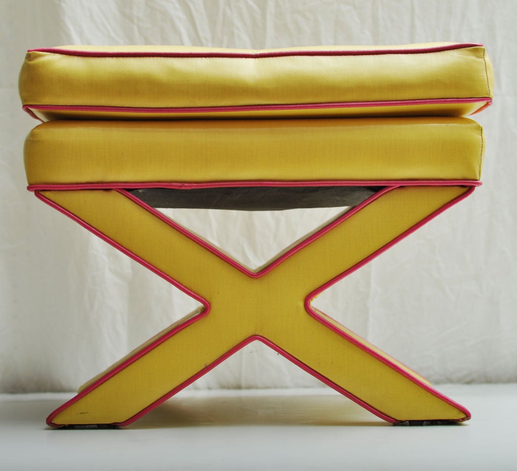 YELLOW WITH PINK TRIM X BASED STOOL WITH ATTACHED CUSHION. OTTOMAN