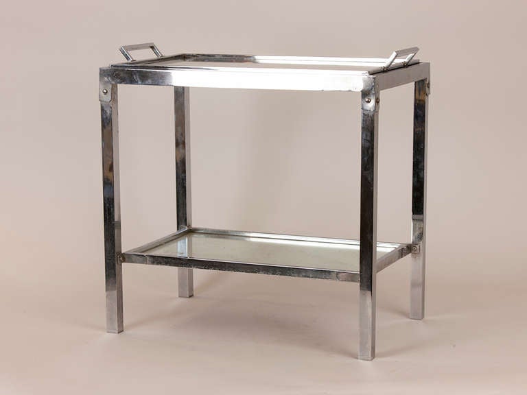 Lovely two tier chrome and mirror side table attributed to Jacques Adnet.  Mirrored tableau is a removable tray with mirrored surface underneath.