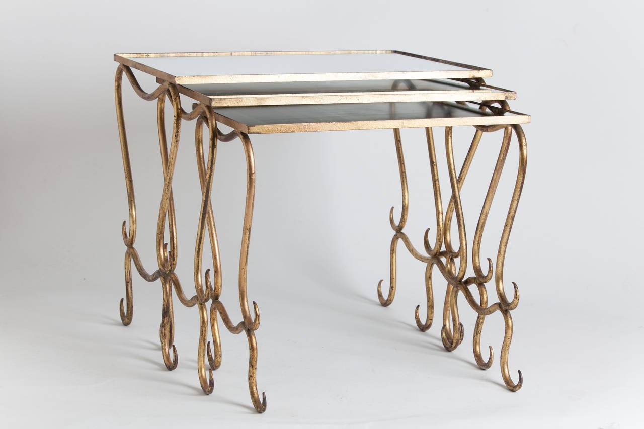 Trio of French gilt nesting tables with original mirror tableau.