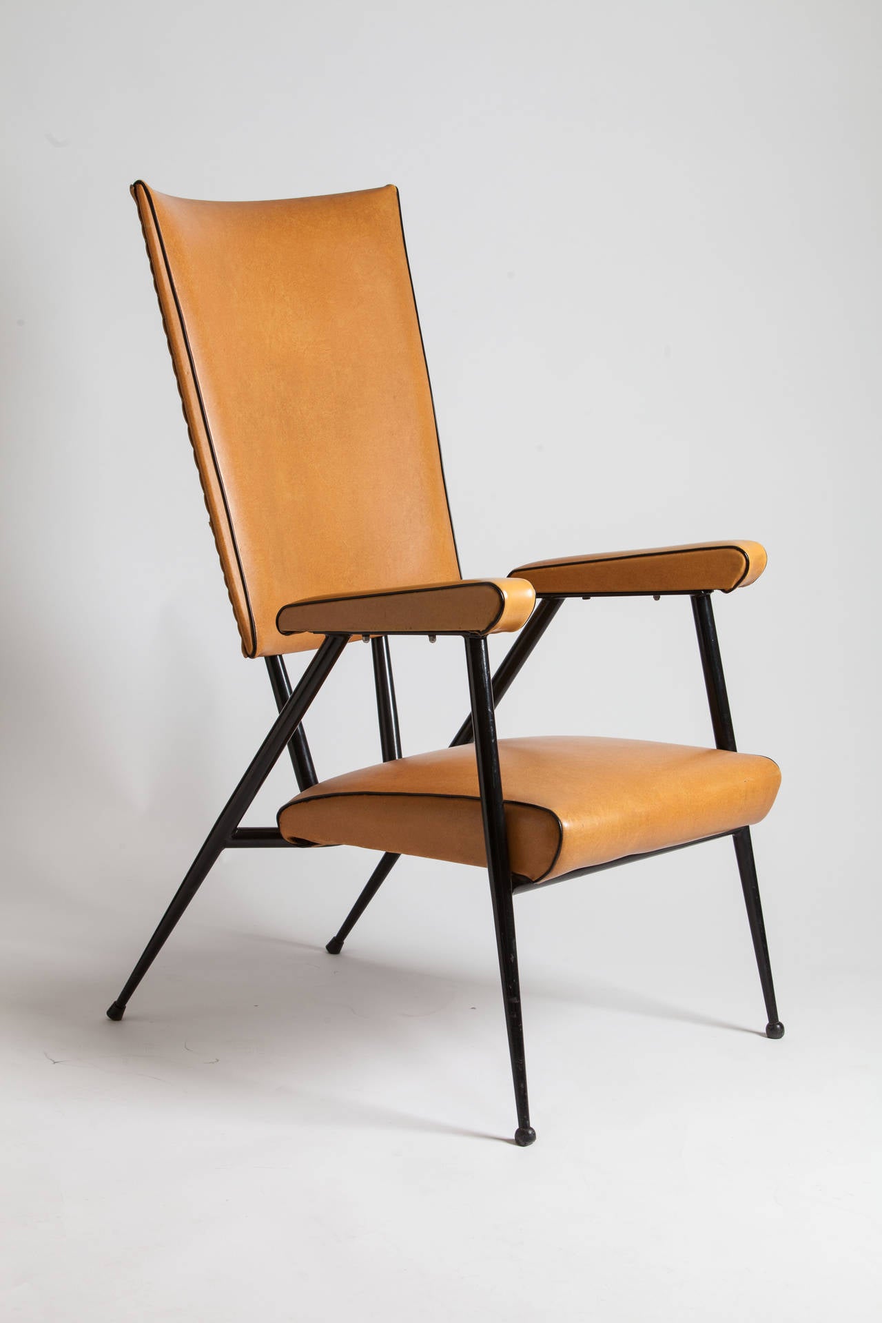 Architectural pair of mid-century French arm chairs in leather and metal.
