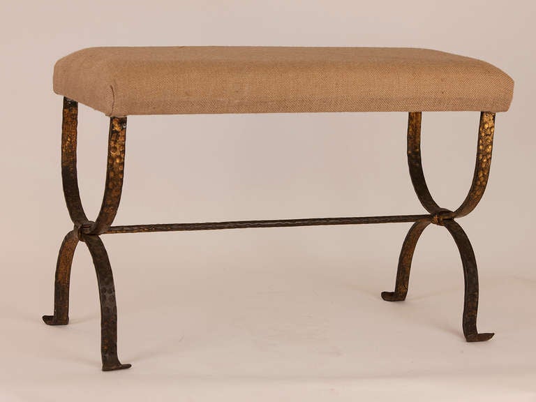 French forged metal hand hammered bench with gilt detail. Burlap upholstery.