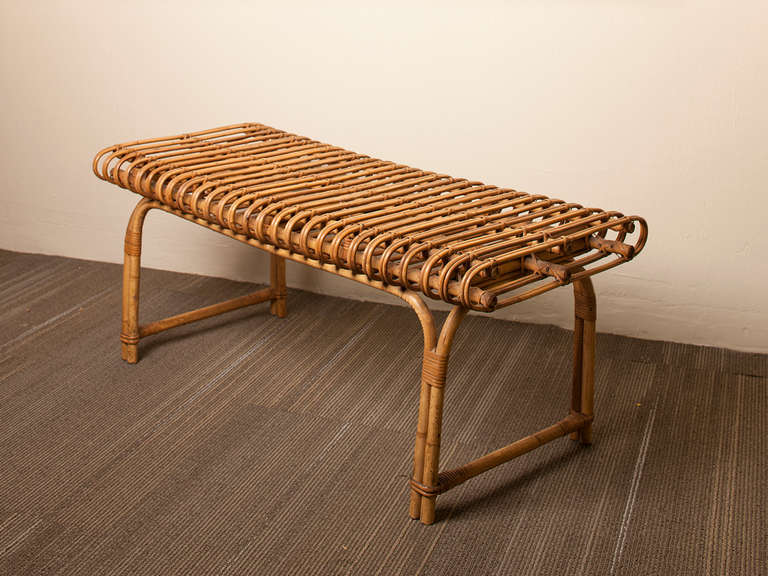 Lovely French curved rattan bench in the manner of Janine Abraham and Dirk Jan Rol.