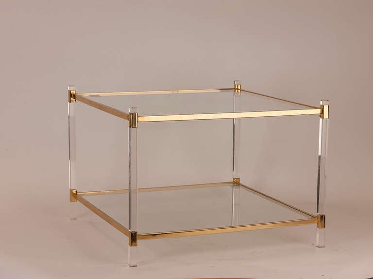 Elegant pair of French Lucite, brass and glass two-tier side tables. Lucite is in pristine condition. Tables can also be used side by side to create a cocktail table.