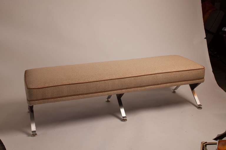Striking Mid Century modern American bench featuring chrome and wood legs and completely reupholstered seat.