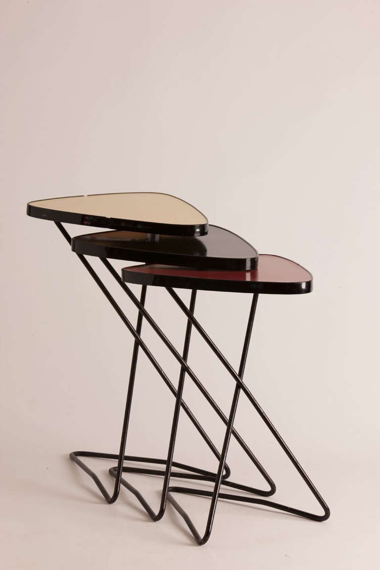 Trio of mid century lacquer and metal Italian nesting tables.  Boldly colored in yellow, black and red.