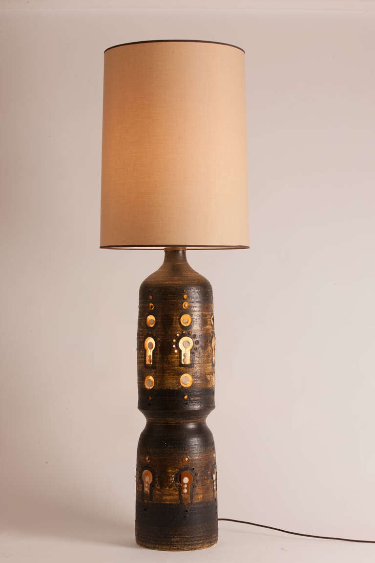 Rare monumental French ceramic lamp created by Georges Pelletier.  Lamp can be illuminated in the base only, socket only or both.  Custom shade made in Paris.