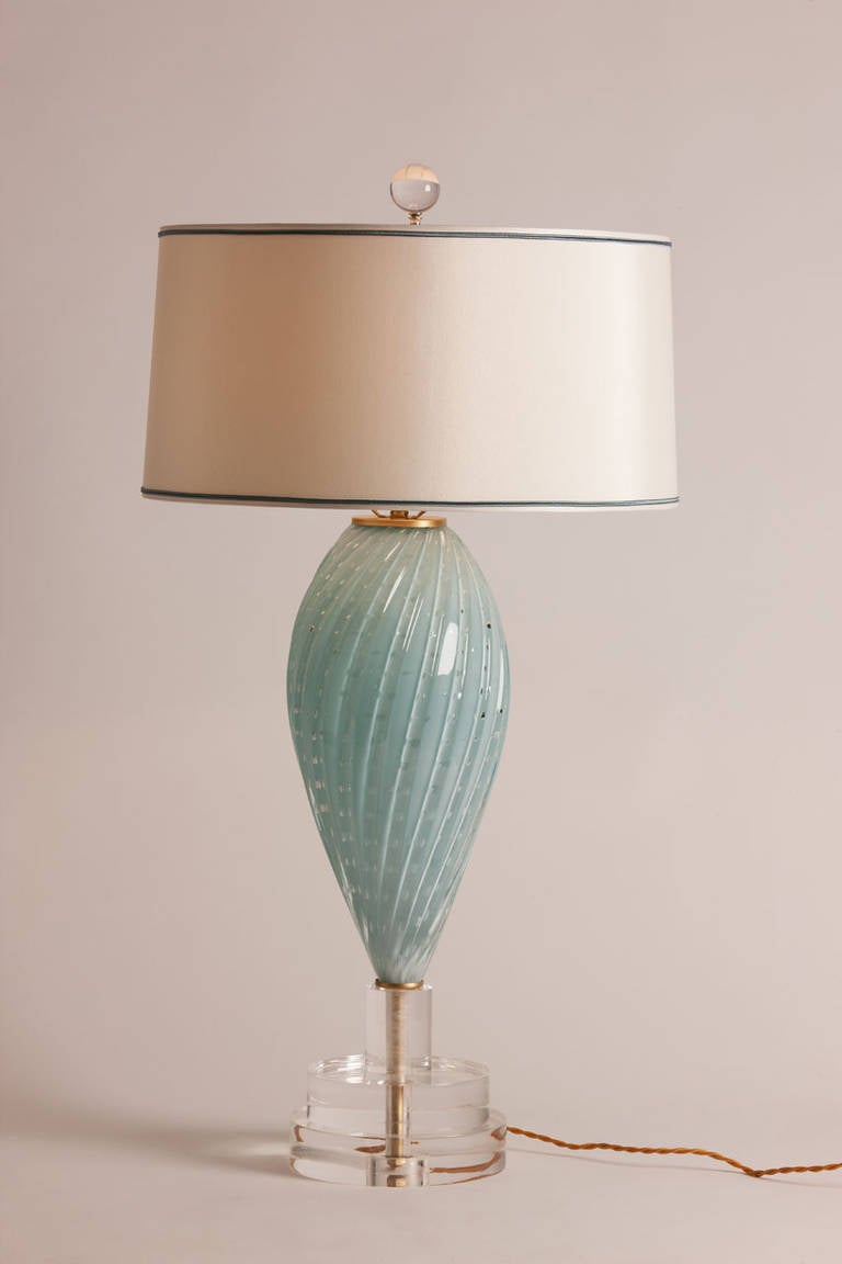 Lovely vintage Murano glass table lamp in pale blue with controlled bubble detail. Rewired and remounted on custom lucite base and featuring a custom trimmed silk shade made in Paris.